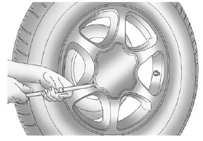 GMS Sierra: Tire Changing. If the wheel has a smooth center cap, place the chisel end of the wheel wrench in the slot on the wheel, and gently pry it out.